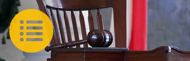 Gavel resting on table with menu symbol overlaid.